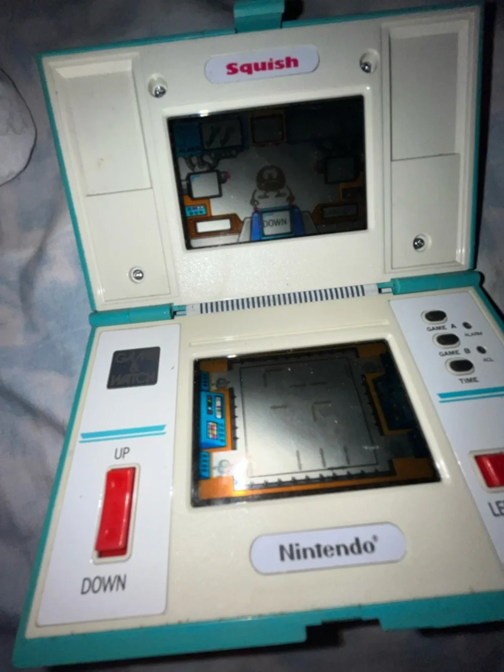 Nintendo Squish Clamshell Handheld in Teal, White and Red Buttons. Works